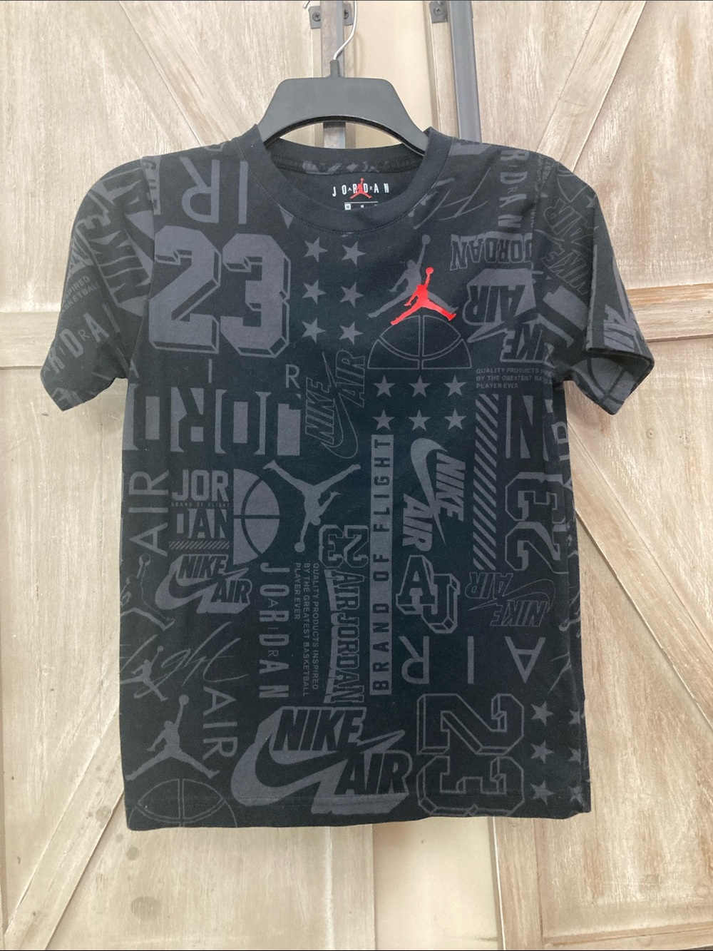 Nike Kids Black All-Over Logo Jordan Tee with Red Jumpman 
Size M (10-12 )